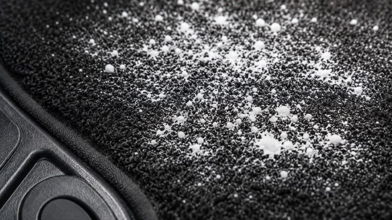 sprinkling baking soda on car carpet for mold odor removal