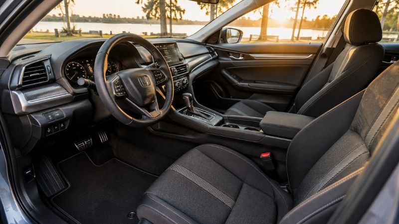 Clean and fully detailed Honda car interior showing spotless black seats and dashboard