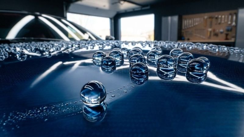Extreme water beading on a slick car hood after a premium graphene car wash