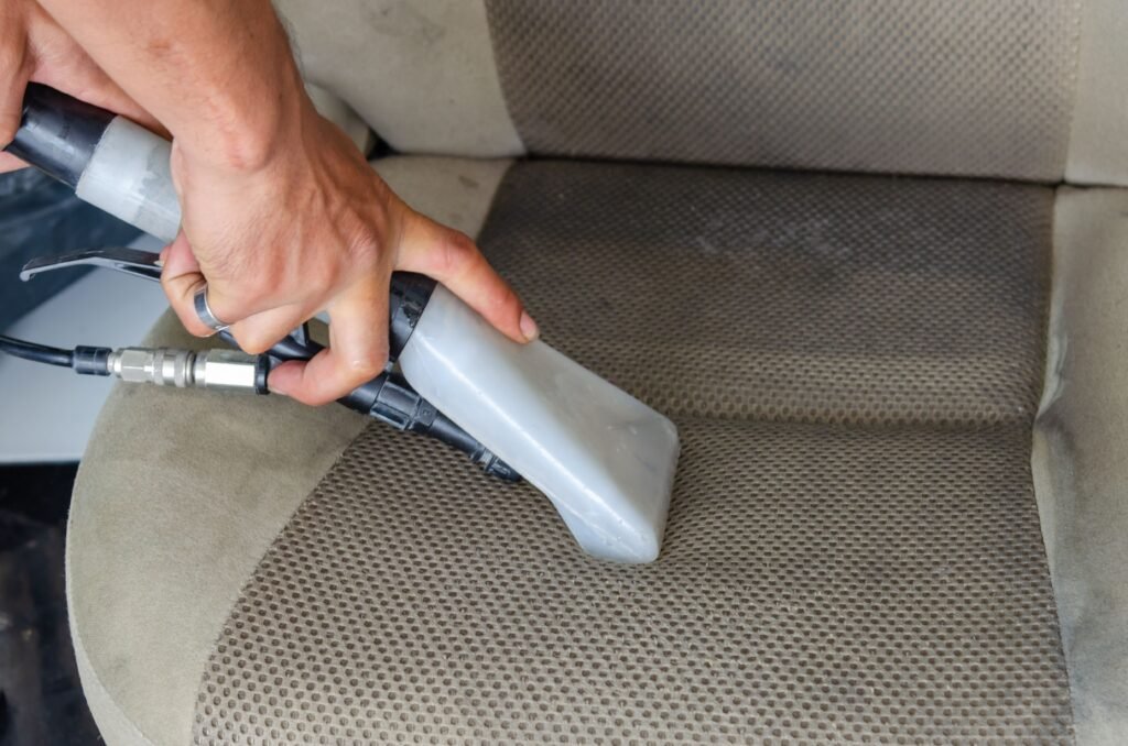 How to Clean Cloth Seats in the Car: A Simple Step-by-Step Guide 2026 Using a vacuum extractor nozzle to deep clean dirty cloth car seats