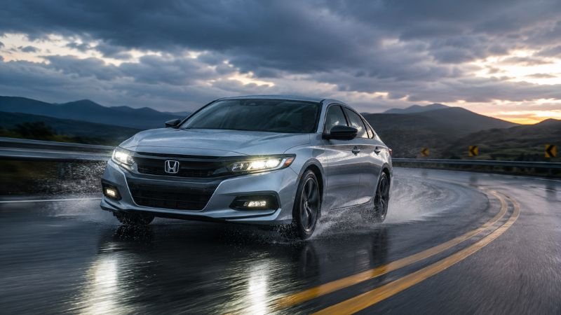 Honda car taking a sharp wet turn demonstrating VSA traction control in action